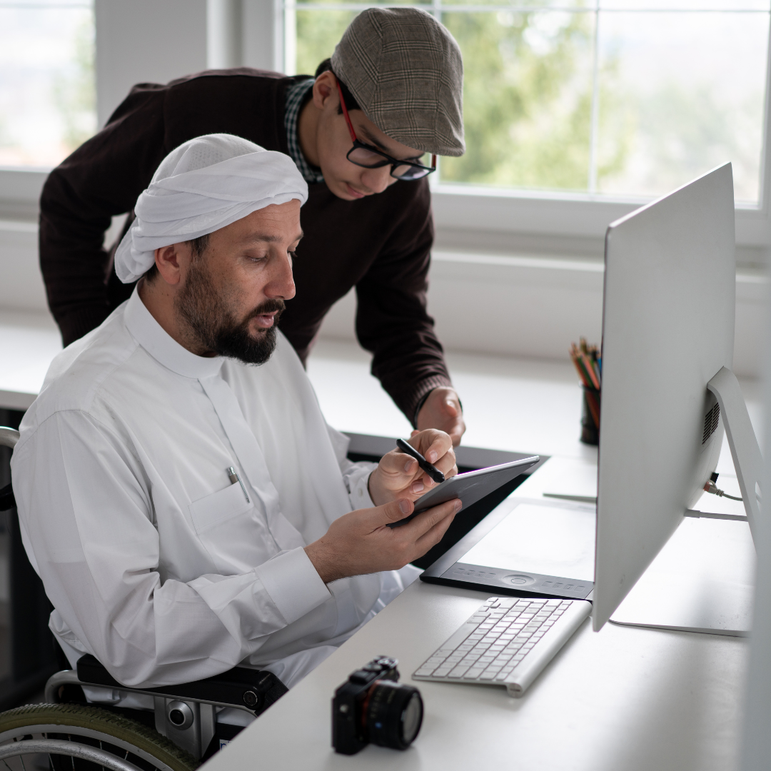 A photo of a Middle Eastern man wearing a head dress and kundura while sitting in a wheelchair