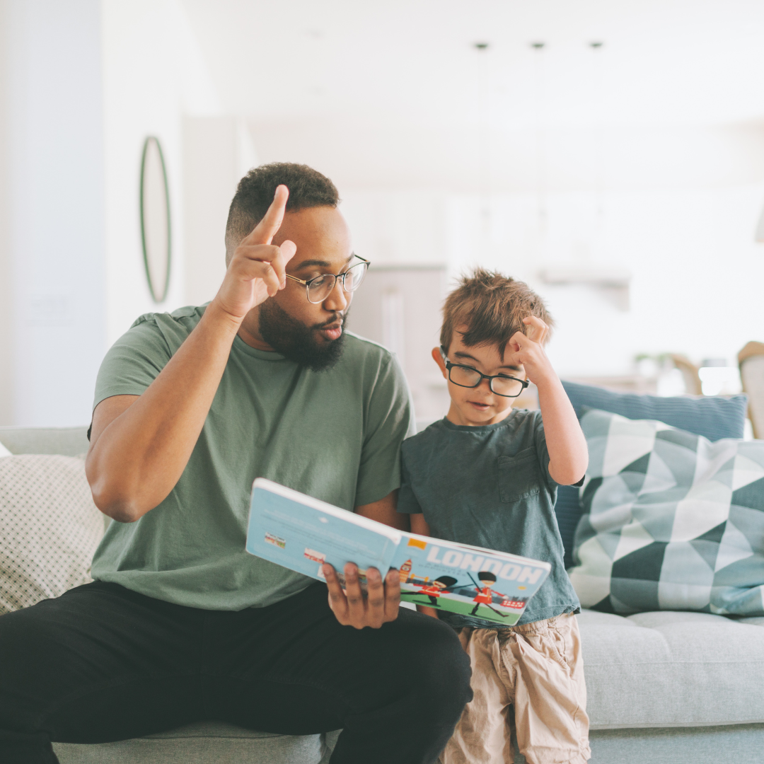 A photo of a father and a boy doing some sign language sign